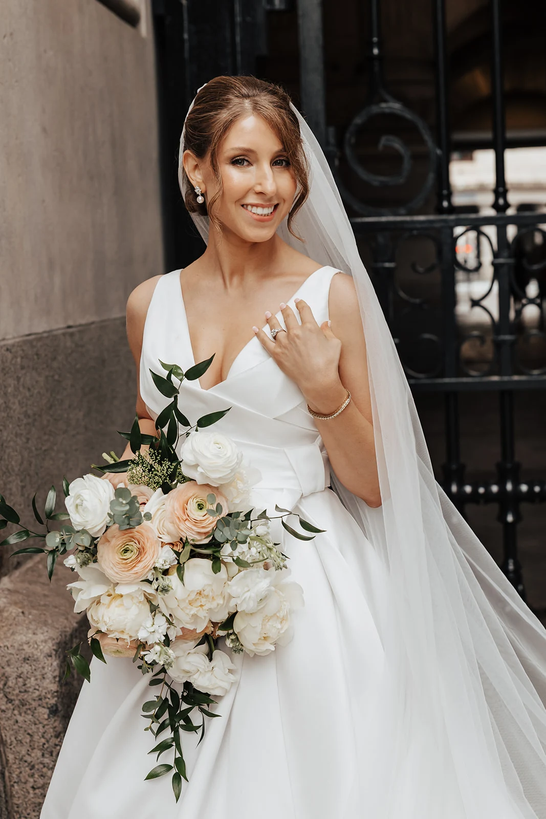 Bride with bouquet and a polished updo